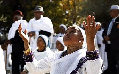 Illustrative: Israeli women from the Ethiopian Jewish community pray during the Sigd holiday marking the desire to 'return to Jerusalem,' as they celebrate from a hilltop in the holy city overlooking the Temple Mount, on November 16, 2017. (AFP Photo/Gali Tibbon)