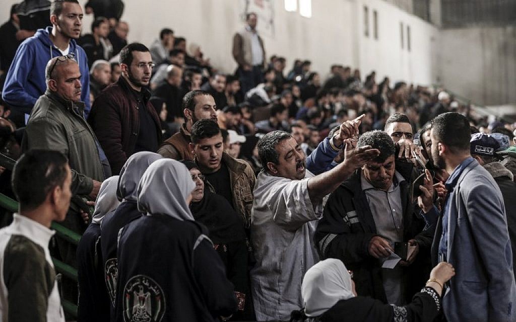 Palestinians argue with Hamas officials and security forces in a makeshift station at a basketball court in Khan Younis in the southern Gaza strip on November 18, 2017 as they await clearance to take a bus to travel through the Rafah border crossing with Egypt. (AFP/Mahmud Hams) Palestinians argue with Hamas officials and security forces in a makeshift station at a basketball court in Khan Younis in the southern Gaza strip on November 18, 2017 as they await clearance to take a bus to travel through the Rafah border crossing with Egypt. (AFP/Mahmud Hams)