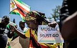 People celebrate during a demonstration demanding the resignation of Zimbabwe's president on November 18, 2017 in Pretoria, South Africa. (AFP PHOTO / GULSHAN KHAN)