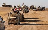 Iraqi forces, supported by members of the Hashed al-Shaabi (Popular Mobilization units), advance in the western desert in the northern Iraqi region of al-Hadar, 105 kilometers south of Mosul, on November 23, 2017, as they attempt to flush out remaining Islamic State group fighters (AFP/Stringer)