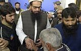 Pakistani head of the Jamaat-ud-Dawa (JuD) terrorist organization Hafiz Saeed (2L) meets with supporters after offering Friday prayers at Jamia AL Qadsia Masjid following his release in Lahore on November 24, 2017. (AFP PHOTO / STR)