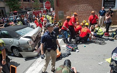 A woman receives first-aid after a car ran into a crowd of protesters in Charlottesville, Virginia, on August 12, 2017. (AFP/PAUL J. RICHARDS)