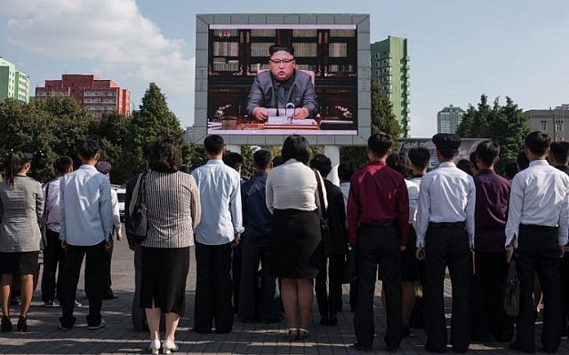 Spectators listen to a television news brodcast of a statment by North Korean leader Kim Jong-Un, before a public television screen outside the central railway station in Pyongyang on September 22, 2017.(AFP PHOTO / Ed JONES) Spectators listen to a television news brodcast of a statment by North Korean leader Kim Jong-Un, before a public television screen outside the central railway station in Pyongyang on September 22, 2017.(AFP PHOTO / Ed JONES)