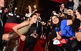 Actor Gal Gadot, left, takes selfies with fans during the premiere of Warner Bros. Pictures' 'Justice League' at Dolby Theatre on November 13, 2017 in Hollywood, California.   (Emma McIntyre/Getty Images/AFP)
