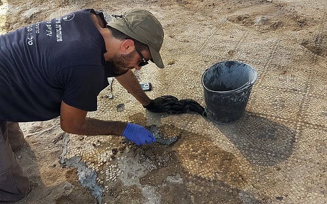 Working on the 1,500-year-old mosaic at Ashdod-Yam. (Anat Rasiuk, Israel Antiquities Authority)