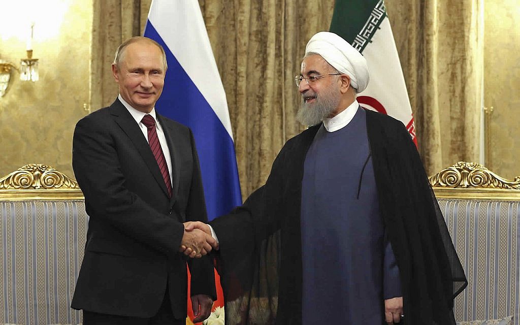 In this photo released by an official website of the office of the Iranian Presidency, Iran's President Hassan Rouhani, right, shakes hands with Russian President Vladimir Putin during their meeting at the Saadabad Palace in Tehran, Iran, November 1, 2017. (Iranian Presidency Office via AP) In this photo released by an official website of the office of the Iranian Presidency, Iran's President Hassan Rouhani, right, shakes hands with Russian President Vladimir Putin during their meeting at the Saadabad Palace in Tehran, Iran, November 1, 2017. (Iranian Presidency Office via AP)