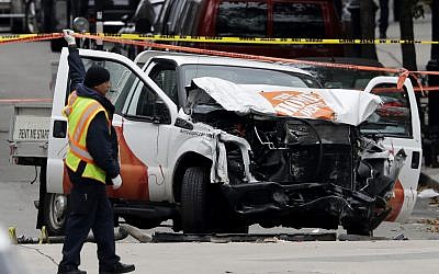 A damaged Home Depot truck remains on the scene Wednesday, Nov. 1, 2017, after the driver mowed down people on a riverfront bike path near the World Trade Center on Tuesday in New York. (AP Photo/Mark Lennihan)