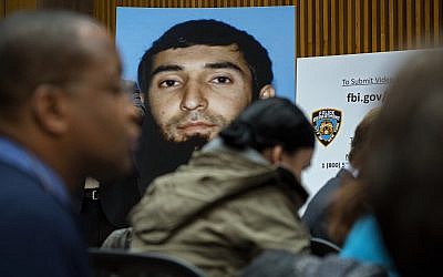 A photo of Sayfullo Saipov is displayed at a news conference at One Police Plaza Wednesday, Nov. 1, 2017, in New York.  Saipov is accused of driving a truck on a bike path that killed several and injured others Tuesday near One World Trade Center.  (AP Photo/Craig Ruttle)