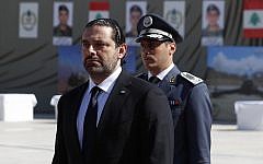 In this photo taken on Friday, Sept. 8, 2017, Lebanese Prime Minister Saad Hariri, left, arrives for a mass funeral of ten Lebanese soldiers at the Lebanese Defense Ministry, in Yarzeh near Beirut, Lebanon. (AP Photo/Hassan Ammar)