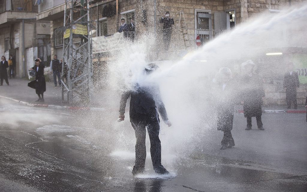 In this Wednesday, March 15, 2017 file photo, an ultra-Orthodox Jew gets hit by a police water canon during a protest against Israeli army conscription in Jerusalem. (AP/Oded Balilty) In this Wednesday, March 15, 2017 file photo, an ultra-Orthodox Jew gets hit by a police water canon during a protest against Israeli army conscription in Jerusalem. (AP/Oded Balilty)