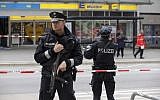 Illustrative: Police officers secure the area after a knife attack at a supermarket in Hamburg, Germany, July 28, 2017. (Markus Scholz/dpa via AP)