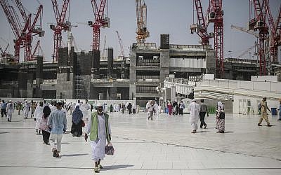 In this file photo from Sept. 15, 2015, Muslim pilgrims walk outside the Grand Mosque in the holy city of Mecca, Saudi Arabia. (AP Photo/Mosa'ab Elshamy, File)