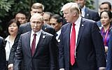 US President Donald Trump, right, and Russia's President Vladimir Putin talk during the family photo session at the APEC Summit in Danang, Vietnam Saturday, November 11, 2017. (Jorge Silva/Pool Photo via AP)