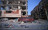 In this photo provided by the Iranian Students News Agency, ISNA, destroyed buildings and a car are seen after an earthquake at the city of Sarpol-e-Zahab in western Iran, November 13, 2017. (Pouria Pakizeh/ISNA via AP)