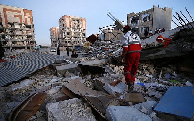 Illustrative image provided by the Iranian Students News Agency, ISNA, shows a rescue worker searches debris for survivors with his sniffing dog after an earthquake at the city of Sarpol-e-Zahab in western Iran, on November 13, 2017. (Pouria Pakizeh/ISNA via AP) Illustrative image provided by the Iranian Students News Agency, ISNA, shows a rescue worker searches debris for survivors with his sniffing dog after an earthquake at the city of Sarpol-e-Zahab in western Iran, on November 13, 2017. (Pouria Pakizeh/ISNA via AP)