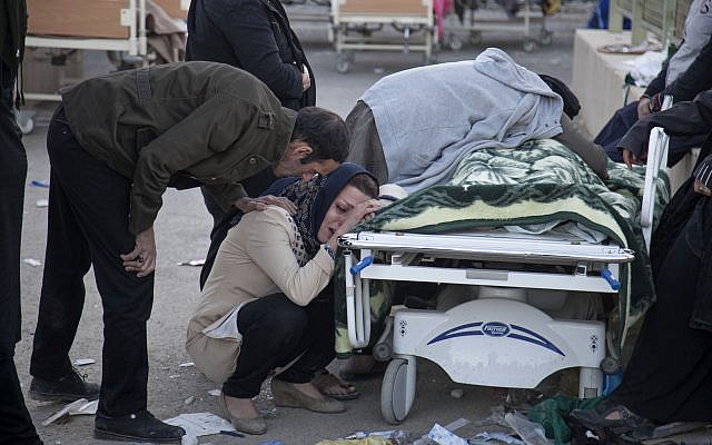 Relatives weep over the body of an earthquake victim, in Sarpol-e-Zahab, western Iran, November 13, 2017. (Farzad Menati/Tasnim News Agency via AP) Relatives weep over the body of an earthquake victim, in Sarpol-e-Zahab, western Iran, November 13, 2017. (Farzad Menati/Tasnim News Agency via AP)