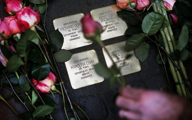 Roses are laid on four "Stolpersteine" (stumbling blocks) for Karolina Cohn and her family in Frankfurt, Germany, Monday, Nov. 13, 2017. (AP Photo/Michael Probst) Roses are laid on four "Stolpersteine" (stumbling blocks) for Karolina Cohn and her family in Frankfurt, Germany, Monday, Nov. 13, 2017. (AP Photo/Michael Probst)