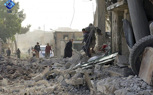 People inspecting damage from airstrikes on a market in Atareb, in the opposition-held countryside outside Aleppo, Syria, November 13, 2017. (Thiqa News via AP) People inspecting damage from airstrikes on a market in Atareb, in the opposition-held countryside outside Aleppo, Syria, November 13, 2017. (Thiqa News via AP)