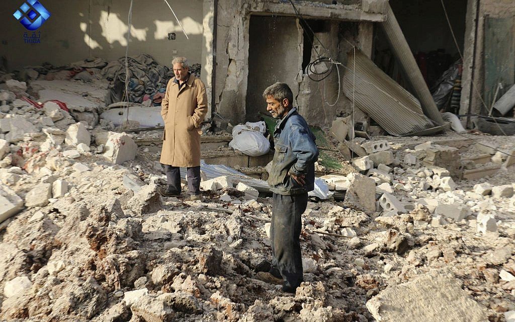 People inspecting damage from airstrikes hit in Atareb town, in the western Aleppo countryside, of Syria, November 13, 2017. (Thiqa News via AP)