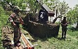 In this April 1996 photo, two fighters from the Lebanese terror group Hezbollah stand near Katyusha rockets in the southern village of Ein Qana, Lebanon. (AP Photo/Mohammed Zaatari)