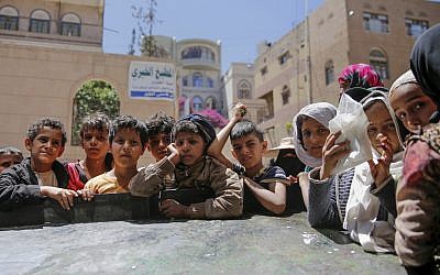 Yemeni children wait to receive food rations provided by a local charity, in Sanaa, Yemen, April, 13, 2017. (AP Photo/Hani Mohammed, File)