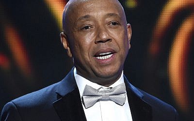 In this Feb. 6, 2015, file photo, hip-hop mogul Russell Simmons presents the Vanguard Award on stage at the 46th NAACP Image Awards in Pasadena, California (Chris Pizzello/Invision/AP, File)