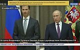In this image made from November 20, 2017, video, Russian President Vladimir Putin, right, stands with Syria's President Bashar Assad in Sochi, Russia. (RU-24 via AP Video)