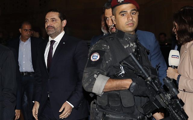 Lebanese Prime Minister Saad Hariri, center, escorted by his bodyguards walks to pray over his father's grave, upon his arrival to Beirut, Lebanon, Tuesday, November 21, 2017. (AP Photo/Hussein Malla) Lebanese Prime Minister Saad Hariri, center, escorted by his bodyguards walks to pray over his father's grave, upon his arrival to Beirut, Lebanon, Tuesday, November 21, 2017. (AP Photo/Hussein Malla)