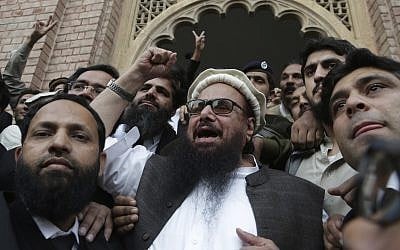 Hafiz Saeed, head of the Pakistani religious party, Jamaat-ud-Dawa, gestures outside a court in Lahore, Pakistan, November 22, 2017. (AP Photo/K.M. Chaudary)