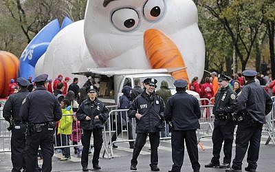 Police officers stand near the site where a large balloon of the character Olaf from "Frozen" is being inflated for the Thanksgiving Day parade in New York, Wednesday, November 22, 2017. (AP Photo/Seth Wenig)