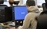 Employees of the Competence Call Center (CCC) work for the Facebook Community Operations Team in Essen, Germany, November 23, 2017. (AP Photo/Martin Meissner)