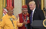 US President Donald Trump, right, meets with Navajo Code Talkers Peter MacDonald, center, and Thomas Begay, left, in the Oval Office of the White House, on November 27, 2017. (AP Photo/Susan Walsh)