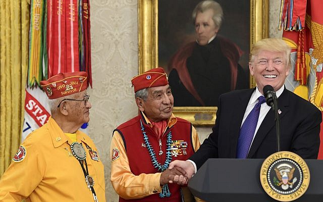 President Donald Trump, right, meets with Navajo Code Talkers Peter MacDonald, center, and Thomas Begay, left, in the Oval Office of the White House in Washington, Monday, Nov. 27, 2017. (AP Photo/Susan Walsh) President Donald Trump, right, meets with Navajo Code Talkers Peter MacDonald, center, and Thomas Begay, left, in the Oval Office of the White House in Washington, Monday, Nov. 27, 2017. (AP Photo/Susan Walsh)