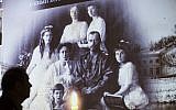 In this file photo taken on Nov. 12, 2015, a visitor walks past a photo showing Russia's last Czar Nicholas II with his family at  the 1914-1945 Russia history exhibition in Moscow, Russia. (AP Photo/Alexander Zemlianichenko, File)