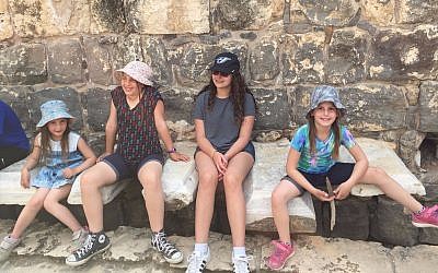 Tourists at Israel's Beit Sh'ean National Park test drive the Roman-era public latrine, March 2017. (Amanda Borschel-Dan/Times of Israel)