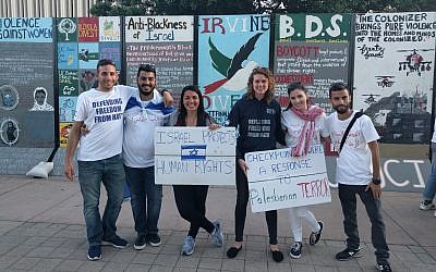 Activists from the group Reservists on Duty, in T-shirts reading 'Defending freedom from hate,' hold a counter protest in front of a Boycott, Divestment and Sanction display on a college campus. (Courtesy Reservists on Duty)