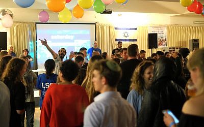 Lone soldiers dance at a Thanksgiving dinner event in Tel Aviv on November 23, 2017. (Judah Ari Gross/Times of Israel)