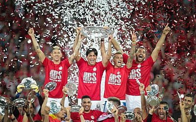 Hapoel Beersheba captain Elyaniv Barda, second from left, together with other members of the soccer team, celebrating after winning at the Israeli soccer league championship at the Turner Stadium in Beersheba, May 8, 2017. (Roy Alima/Flash90)