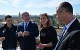 Prime Minister Benjamin Netanyahu, second left, and Tourism Minister Yariv Levin, right, seen with Israel's 3,000,000th visitor this year, Ioana Isac, second right, and her partner, Mihai Georgescu from Romania, at the Tower of David Museum in the Old City of Jerusalem, November 7, 2017. (Kobi Gideon/GPO)