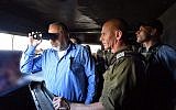 Defense Minister Avigdor Liberman looking through binoculars during a visit to the Israel's northern border, November 14, 2017. Ariel Hermoni/Ministry of Defense)