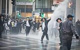 Extremist ultra-Orthodox demonstrators, protesting against the army draft, block the entrance to Jerusalem on November 26, 2017. (Flash90)