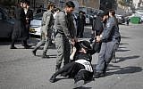 Ultra-Orthodox Jewish men clash with police during a protest against the arrest of a religious seminary student who failed to comply with a recruitment order, next to the army draft office in Jerusalem, November 28, 2017. (Flash90)