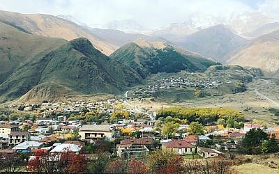 A view of Mount Kazbegi and the Gergeti Church overlooking the Georgian village of Kazbegi (Jessica Steinberg/Times of Israel)