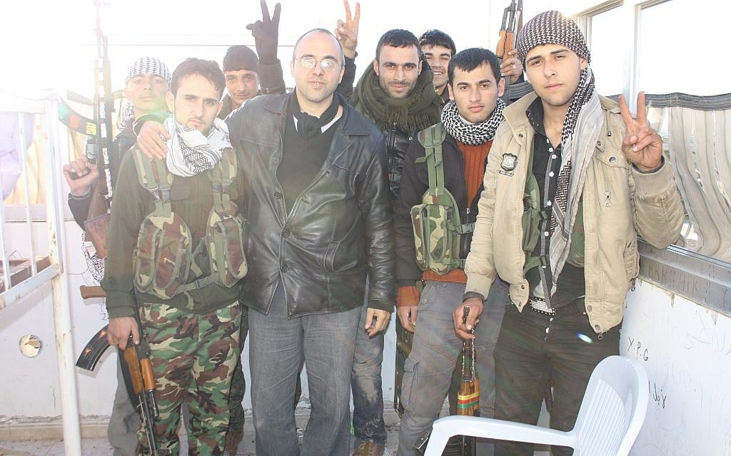 Jonathan Spyer, wearing a black leather jacket, meets with Kurdish YPG fighters in northern Syria in 2013. (Courtesy) Jonathan Spyer, wearing a black leather jacket, meets with Kurdish YPG fighters in northern Syria in 2013. (Courtesy)
