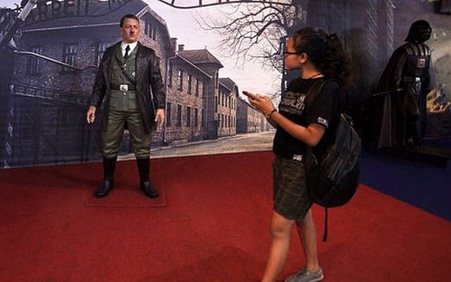 In this Wednesday, Nov. 8, 2017 photo, a visitor walks past the wax figure of Adolf Hitler displayed against the backdrop of an image of Nazi Death Camp Auschwitz-Birkenau next to Star Wars character Darth Vader, right, at De Mata Museum in Yogyakarta, Indonesia. (AP Photo/Slamet Riyadi) In this Wednesday, Nov. 8, 2017 photo, a visitor walks past the wax figure of Adolf Hitler displayed against the backdrop of an image of Nazi Death Camp Auschwitz-Birkenau next to Star Wars character Darth Vader, right, at De Mata Museum in Yogyakarta, Indonesia. (AP Photo/Slamet Riyadi)