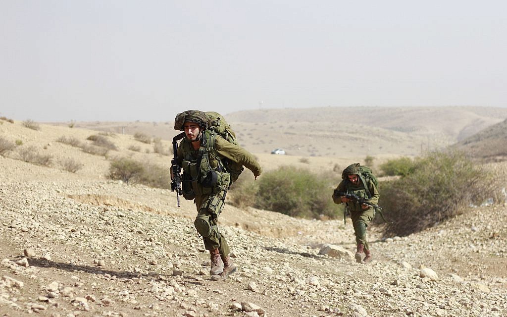 Soldiers from the IDF's Kfir Brigade run to capture a hill during a training exercise in the Jordan Valley on November 28, 2017. (Judah Ari Gross/Times of Israel)