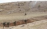 Soldiers from the IDF's Kfir Brigade run into a valley in order to destroy a simulated rocket launcher during a training exercise in the Jordan Valley on November 28, 2017. (Judah Ari Gross/Times of Israel)