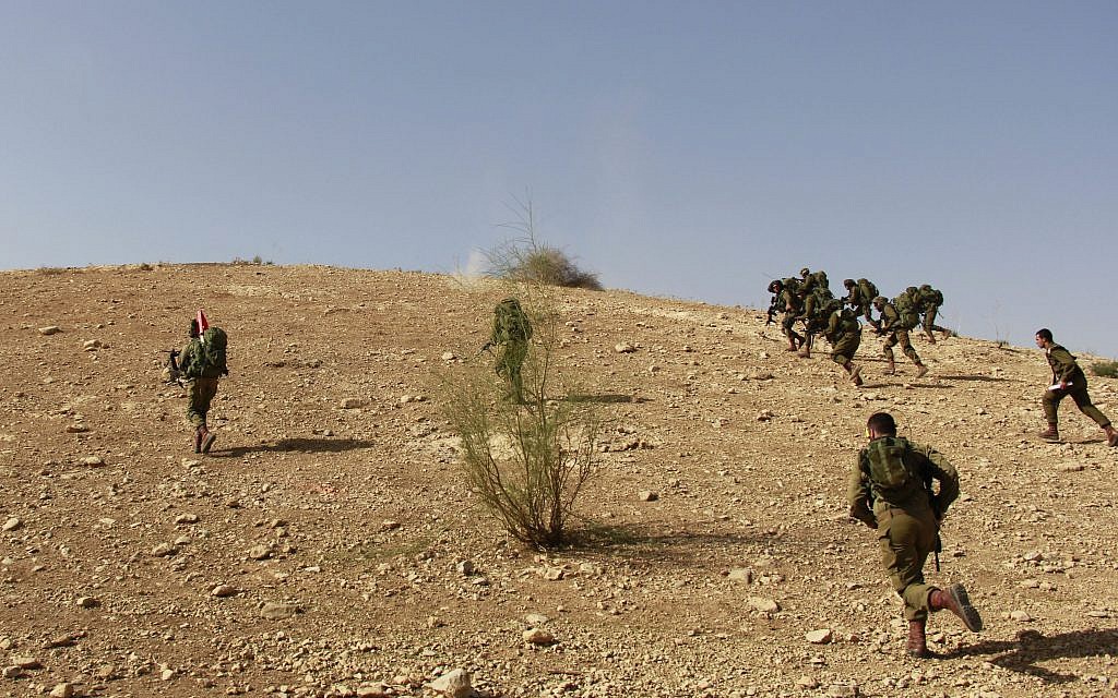 Cpt. Sofar Ganem, bottom right, and his soldiers from the IDF's Kfir Brigade run to capture a hill during a training exercise in the Jordan Valley on November 28, 2017. (Judah Ari Gross/Times of Israel)