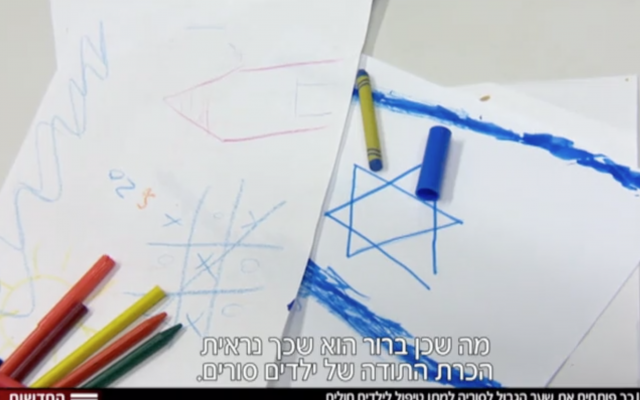Syrian children paint at Ziv hospital in Safed, where they are receiving medical treatment, November 2017 (Hadashot TV screenshot)