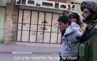 Footage of Dean Issacharoff (right) leading away a Palestinian in Hebron in March 2014. (Screen Capture/B'Tselem)